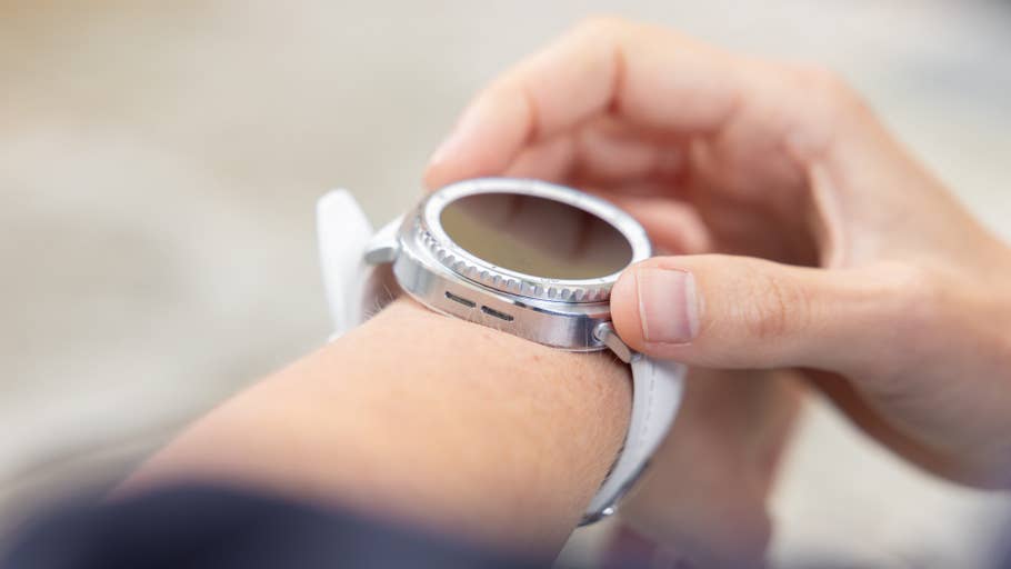 A person adjusting a Samsung Galaxy Watch 8 Classic on their wrist.