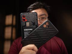 A person holding a Samsung Galaxy XCover 7 Pro smartphone and its protective case.