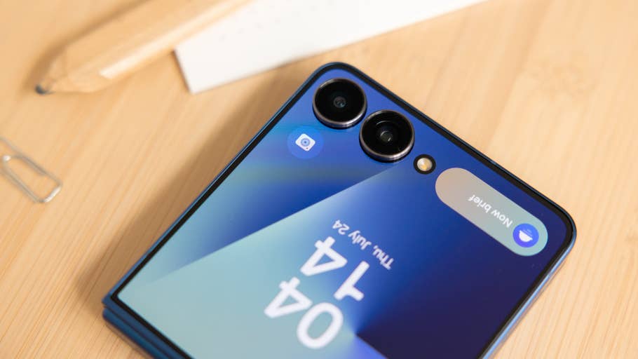 Close-up of a Samsung Galaxy Z Flip7 smartphone showing two cameras and a partially visible screen.