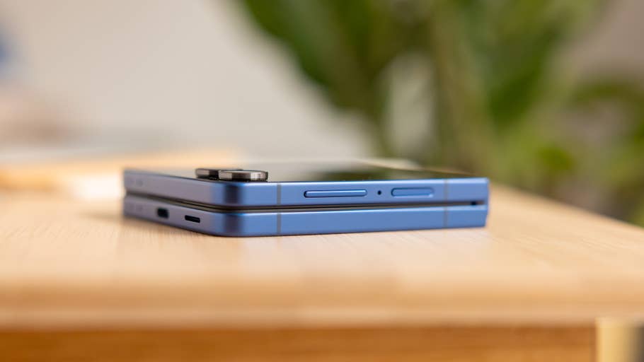 A Samsung Galaxy Z Flip 7 smartphone folded on a wooden surface.