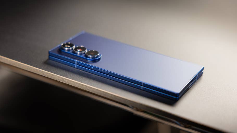 A blue Samsung Galaxy Z Fold7 smartphone lying on a wooden surface.