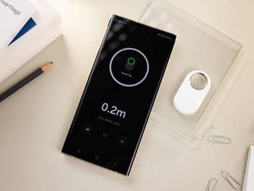 Samsung Galaxy SmartTag 2 viewed next to the Galaxy S23 Ultra smartphone