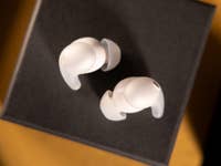 Top view of Sony LinkBuds Fit wireless earbuds on a black surface.