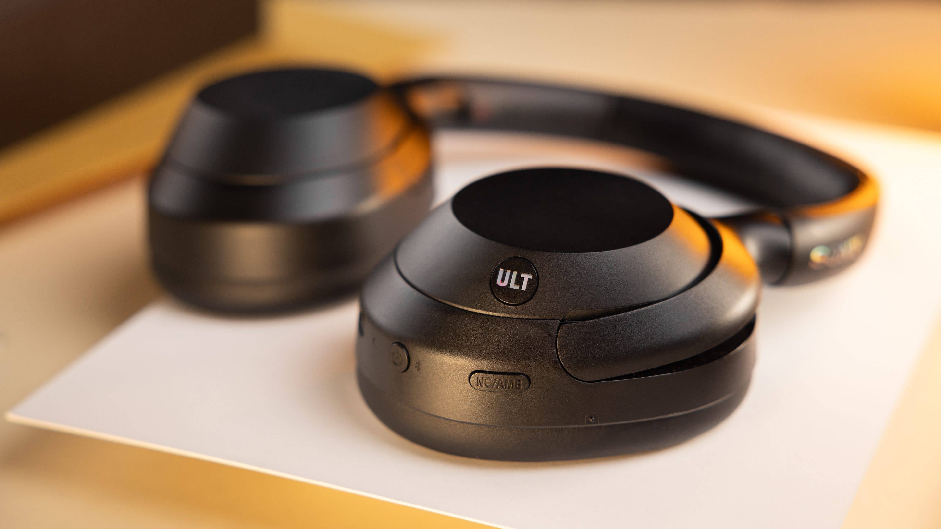 Close-up of black Sony headphones featuring 'ULT' branding on the earcup.