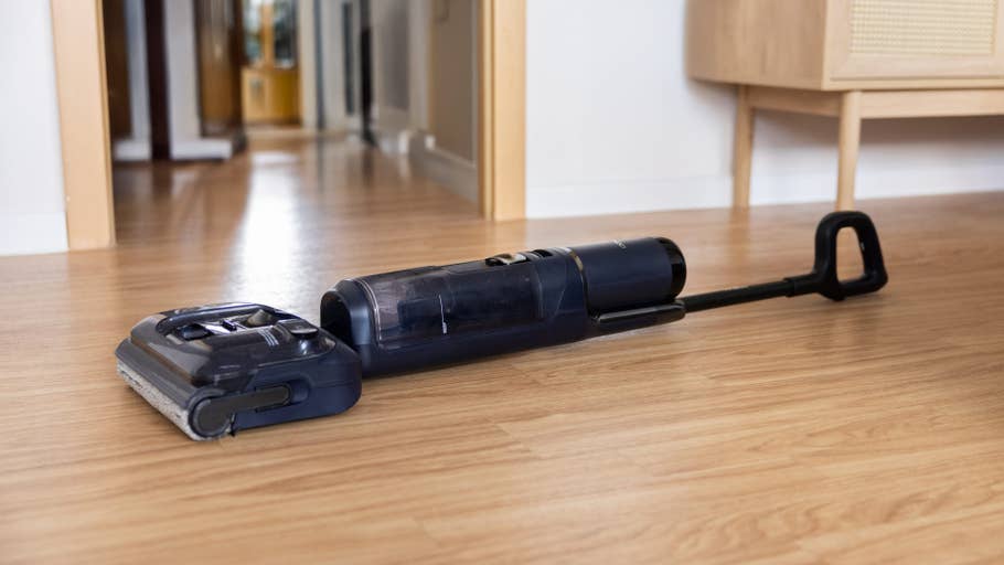 A Tineco Floor One S7 Stretch cordless vacuum cleaner on a wooden floor..