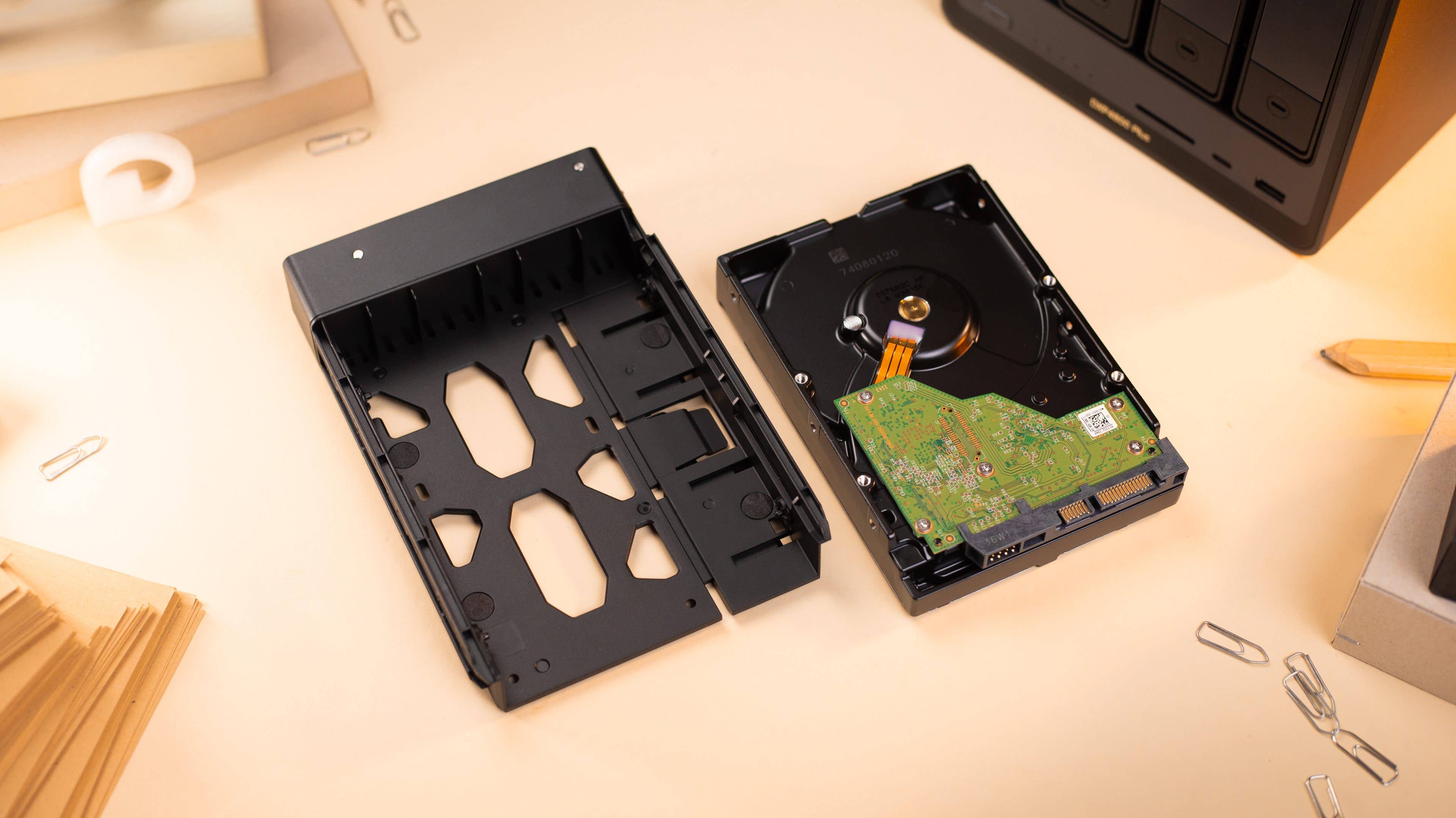 UGreen DXP4800 Plus drive bay next to a hard drive