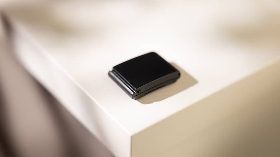 A small black device resting on a white table.