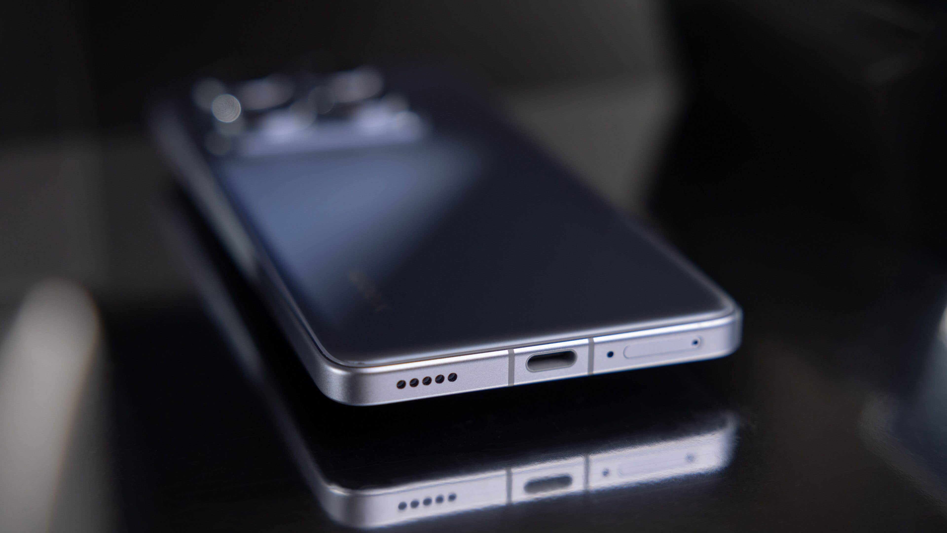 Close-up of a Xiaomi 14T Pro smartphone showing its sleek design and charging port. Close-up of a Xiaomi 14T Pro smartphone showing its sleek design and charging port.