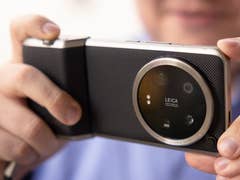 Xiaomi 14 Ultra held horizontally with Pro Photography Kit