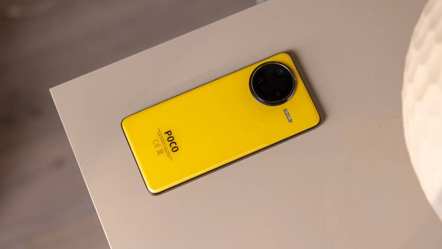 A yellow Poco F7 Ultra smartphone lies against a light-colored surface.