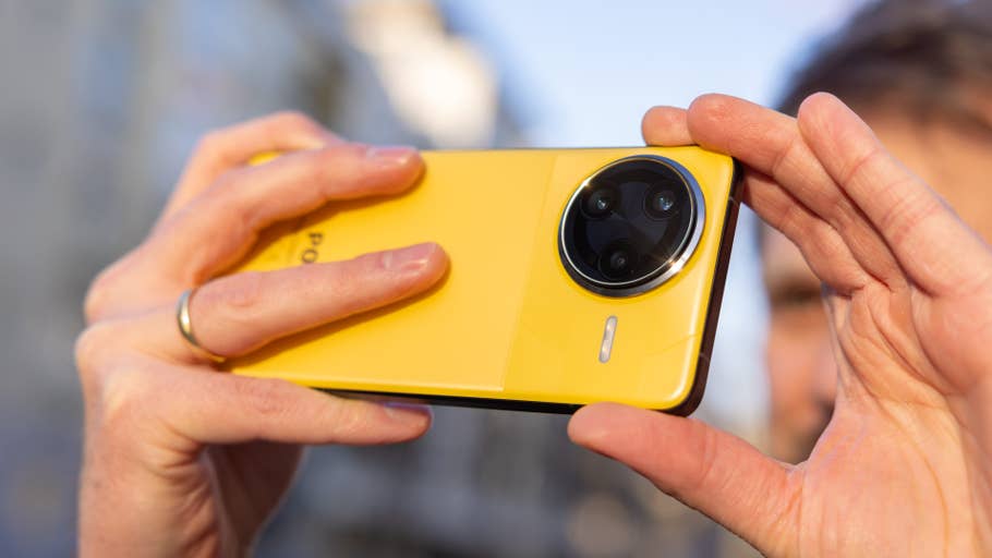 A person holds a yellow Xiaomi F7 Ultra smartphone and prepares to take a photo.