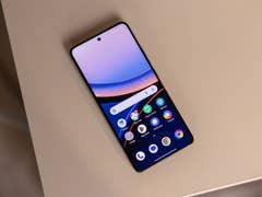 A Poco F7 Ultra smartphone displaying a colorful home screen on a beige surface.