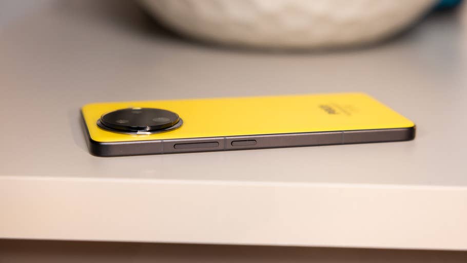 A yellow Poco F7 Ultra smartphone lies on a surface with a round camera module and side buttons.