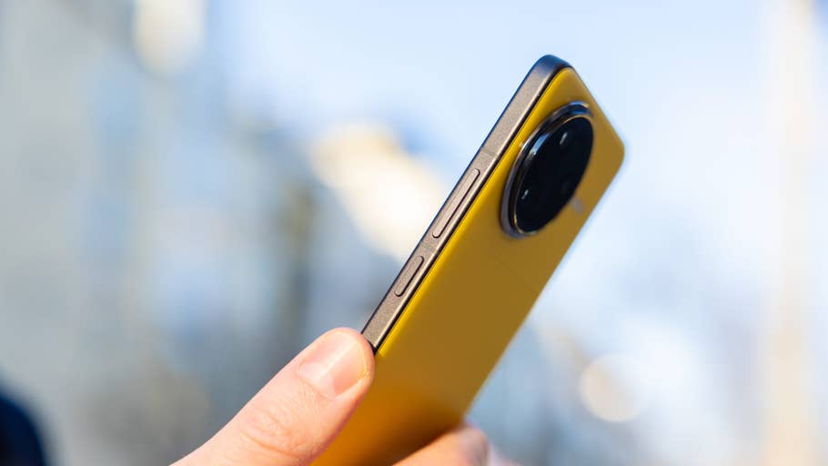 A hand holds a yellow Poco F7 Ultra smartphone showing its side buttons and camera.