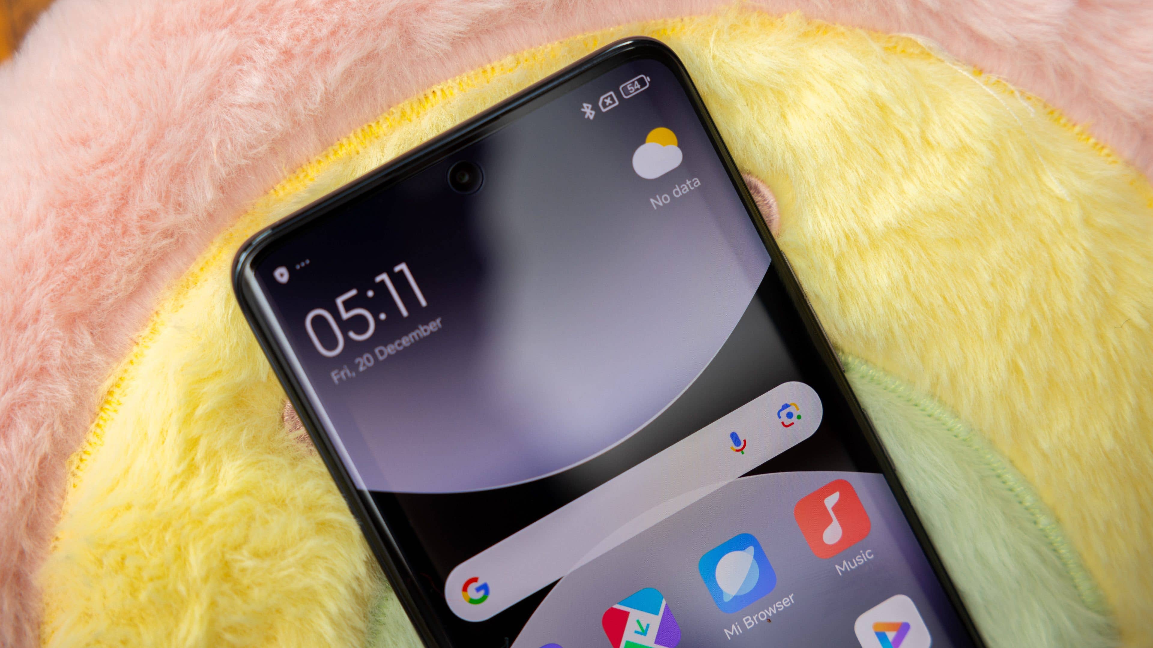 Close-up of a Xiaomi Redmi Note 14 Pro 5G smartphone displaying the time and weather.
