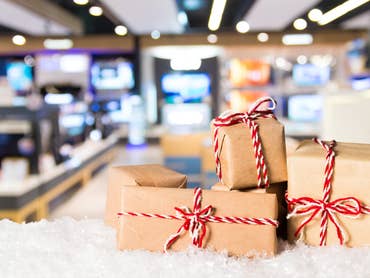 Christmas-themed delivery boxes in front of a technology store picture