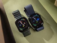 Two Apple Watch Series 10 models on a green surface, one with a green strap and the other with a blue strap.