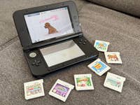 A Nintendo 3DS System and some game cartridges.