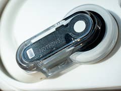 Close-up of Nothing Ear Open wireless earbuds with a transparent casing.