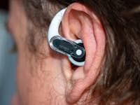 Close-up of a Nothing Ear Open wireless earbud in a person's ear.