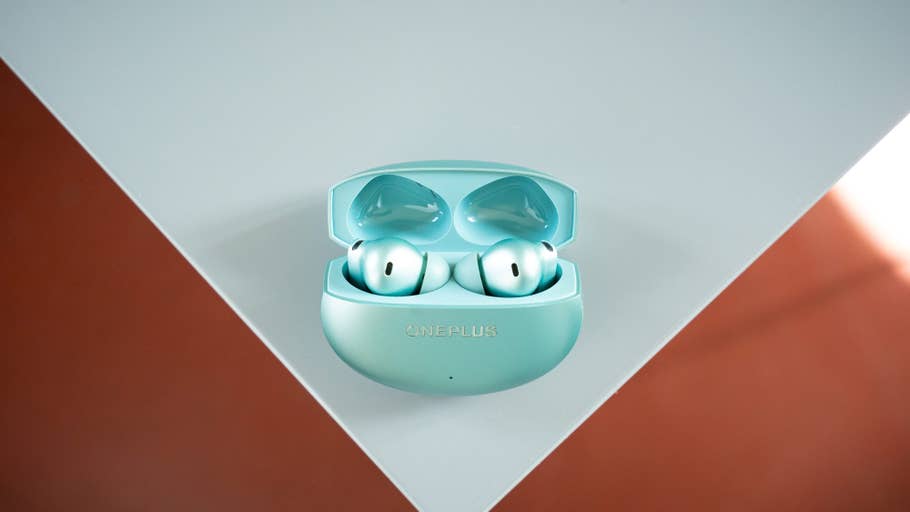 A pair of the OnePlus Buds 4 in their charging case, presented on a bright surface.