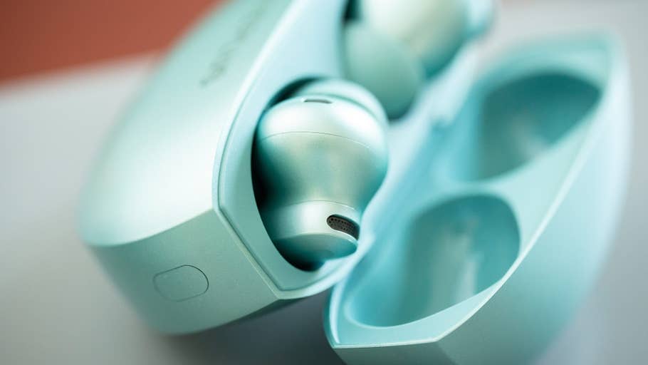 Close-up of the OnePlus Buds 4 in their charging case.