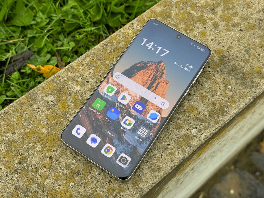 Oppo Find X8 Pro smartphone on a stone surface with colorful mountain background.