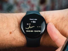 Front view of the Google Pixel Watch 2 worn on a straight wrist with its screen switched on.
