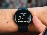 Front view of the Google Pixel Watch 2 worn on a straight wrist with its screen switched on.