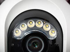 Close-up of a Reolink Atlas PT Ultra security camera featuring LED lights around the lens.