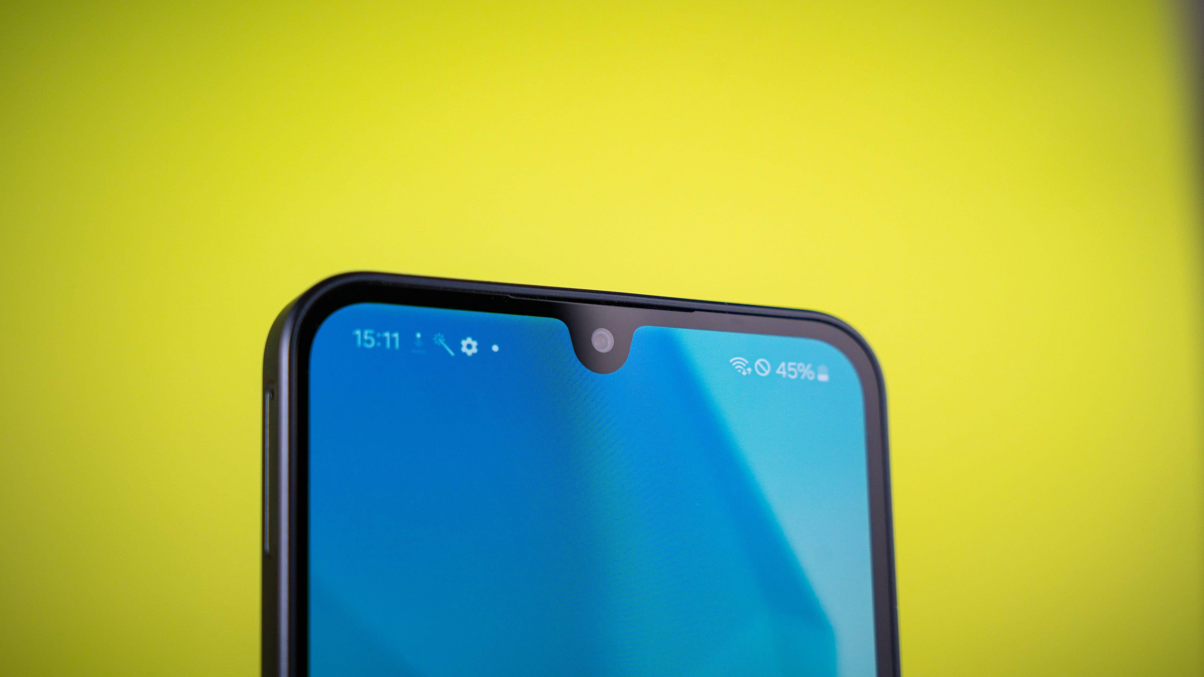 Close-up of a Samsung Galaxy A16 5G smartphone's top with a blue screen and a notch for the front camera.
