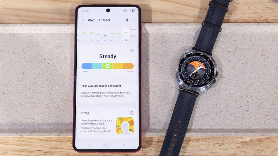 A Samsung Galaxy Watch 8 Classic next to a smartphone displaying vascular load health data.