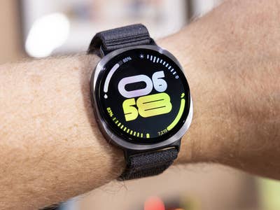 A Samsung Galaxy Watch 8 displaying the time 06:58 with a black strap.