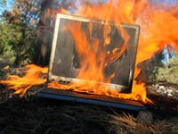 A burning laptop on the ground