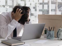 Man at his desk regretting things