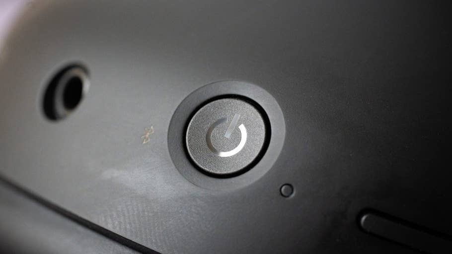 Close-up of the power button on the Sony WH-1000XM6 headphones.