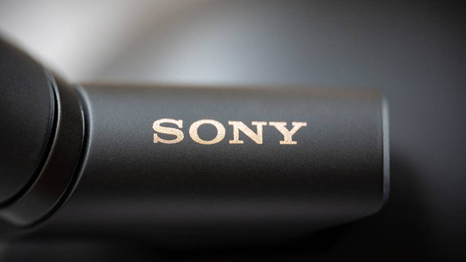 Close-up of the Sony logo on a black surface, part of the WH-1000XM6 headphones.