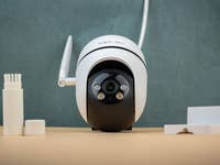 A Tapo C501 security camera with accessories on a table.