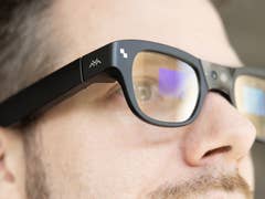 Close-up of a person wearing TCL RayNeo X3 Pro smart glasses.
