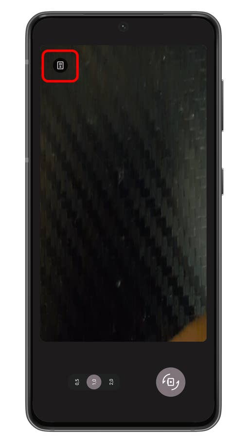 A smartphone screen displaying a camera interface with a button in the corner.