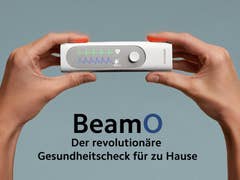 A person holding the Withings BeamO device