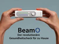 A person holding the Withings BeamO device