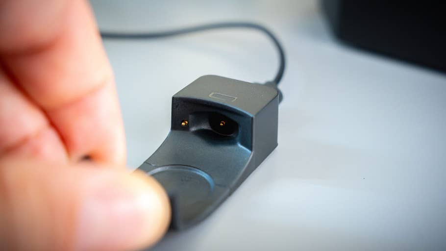 Close-up of a black charging station for the Withings ScanWatch Nova.