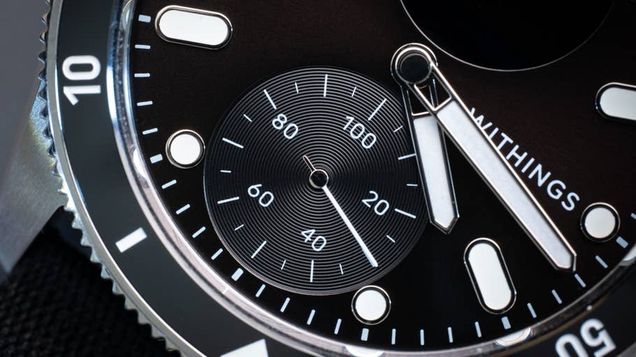 Close-up of the black dial and silver hands of the Withings ScanWatch Nova.