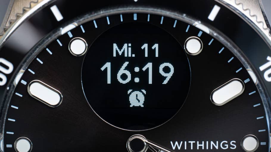 Close-up of a Withings ScanWatch Nova showing the time as 16:19 and the day/date, Wed 11.
