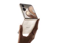 A person holding a Xiaomi Mix Flip 2 smartphone in a partially open position.