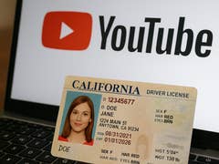 A US driver's license on an open laptop.